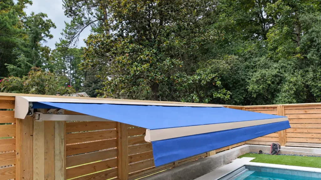 KE Domina Retractable Awning with folding arms extended over the pool