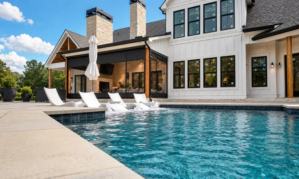 Custom-made motorized retractable screens help enclose this poolside pavilion while preserving the view and connection to the outdoor space.